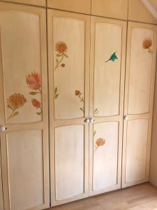 aged cupboards with proteas and birds