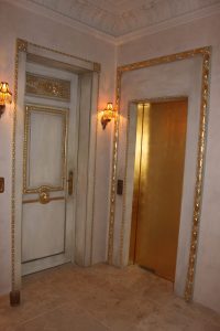 aged doors with gold leaf detail