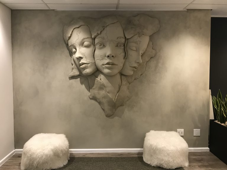 3-D printed faces to blend into soft cloudy wall